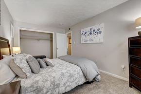Denton apartment for rent - a bedroom with a bed and a closet
