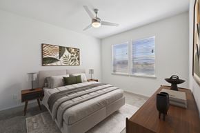 Farmersville apartment for rent - A bedroom with a large bed and a ceiling fan.