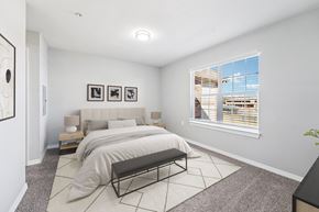 Oklahoma City apartment for rent - A bedroom with a large bed and a bench in front of it.