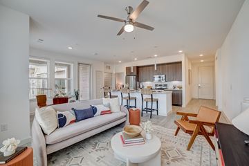 Pflugerville apartment for rent - A living room with a white couch and a ceiling fan.