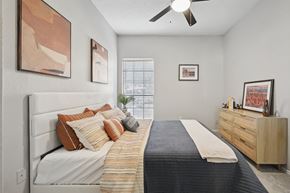 Richardson apartment for rent - A bedroom with a bed, dresser, and artwork on the walls.
