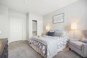 Denver apartment for rent - a bedroom with a bed and a chair