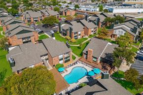 Carrolton apartment for rent - an aerial view of a neighborhood of houses with a swimming pool