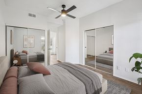 Dallas apartment for rent - A bedroom with a large bed and a ceiling fan.