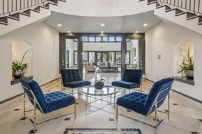 Carrollton townhouse for rent - Clubhouse lounge with sofas, fireplace, tall windows, and decorative ceiling beams.
