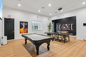 Lewisville apartment for rent - A pool table in a room with a painting of a giraffe on the wall.