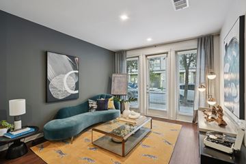 Fort Worth apartment for rent - A living room with a green sofa and a coffee table.