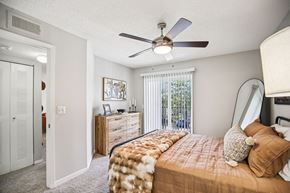 Hendersonville apartment for rent - A bedroom with a bed, dresser, and a ceiling fan.
