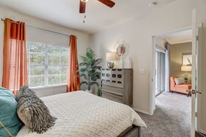 New Braunfels apartment for rent - a bedroom with a large bed and a ceiling fan