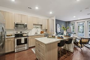 Fort Worth apartment for rent - A modern kitchen with wooden cabinets and stainless steel appliances.