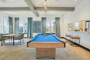 Farmersville apartment for rent - A room with a pool table and a bar area.