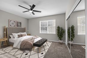 Memphis apartment for rent - an open bedroom with a large bed and a ceiling fan