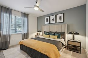 Fort Worth apartment for rent - A bedroom with a bed, nightstand, and a ceiling fan.
