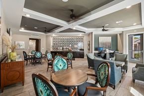 Garland apartment for rent - A modern dining room with a glass backsplash and patterned chairs.