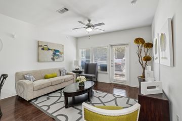 Dallas apartment for rent - A living room with a couch, coffee table, and a painting on the wall.