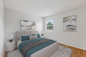 Austin apartment for rent - A bedroom with a large bed and two paintings on the wall.