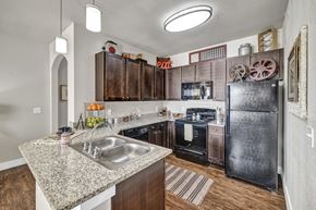 San Antonio apartment for rent - a kitchen with stainless steel appliances and granite counter tops