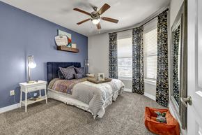 San Antonio apartment for rent - a bedroom with blue walls and a bed and a ceiling fan