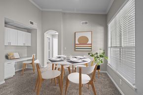 Memphis apartment for rent - a dining room with a table and chairs and a large window