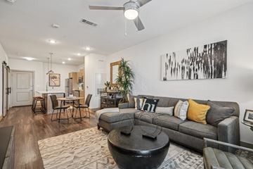 San Antonio apartment for rent - A modern living room with a grey couch and a coffee table.