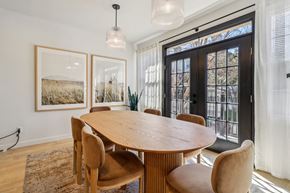 Dallas apartment for rent - A dining room with a wooden table and chairs.
