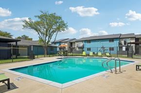 Mesquite apartment for rent - A swimming pool in a sunny day surrounded by a fence.