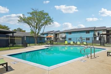 Mesquite apartment for rent - A swimming pool surrounded by a fence and a tree.