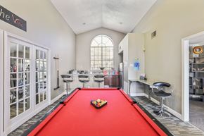 Austin apartment for rent - A pool table with a red cloth and a set of pool balls in the middle.