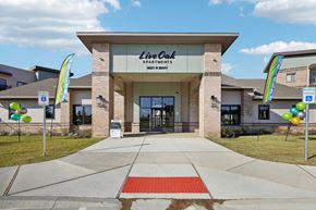 Cleburne apartment for rent - the front of the life coach apartments building with balloons