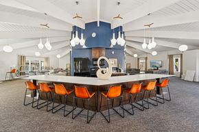 Oklahoma City apartment for rent - A large conference room with a long table and orange chairs.