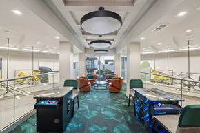 Fort Worth apartment for rent - A modern office space with a blue carpet and various seating arrangements.