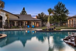 Buda apartment for rent - Resort-style pool at The Bradford in Buda, TX with twilight reflections and palms.