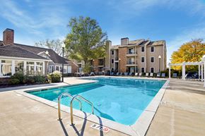 Hendersonville apartment for rent - A swimming pool surrounded by a concrete floor and a metal ladder.