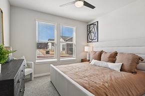 Fort Worth apartment for rent - A bedroom with a large bed and a ceiling fan.