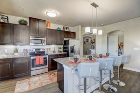 Allen apartment for rent - a kitchen with stainless steel appliances and a table with chairs