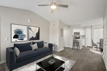 Oklahoma City apartment for rent - A living room with a dark blue couch and a coffee table in the center.