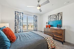 Mckinney apartment for rent - A bedroom with a bed, a dresser, and a painting on the wall.