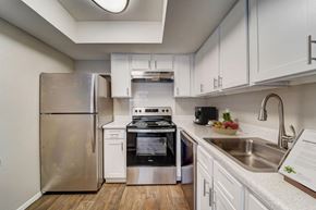 Houston apartment for rent - a kitchen with stainless steel appliances and white cabinets