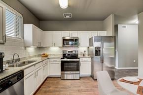 Forney apartment for rent - a kitchen with stainless steel appliances and white cabinets