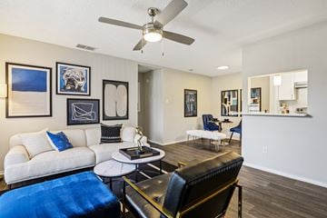 Austin apartment for rent - A living room with a white couch and a blue ottoman.