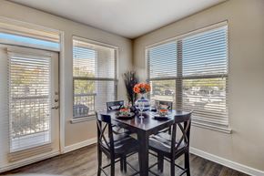 Allen apartment for rent - a dining room with two windows and a table with chairs