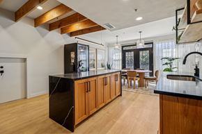Dallas apartment for rent - A modern kitchen with wooden cabinets and black countertops.