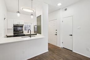 Dallas apartment for rent - A kitchen with white cabinets and a white countertop with a sink.
