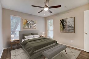 Austin apartment for rent - a bedroom with a bed and a ceiling fan