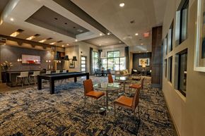 Austin apartment for rent - A large room with a pool table and chairs.