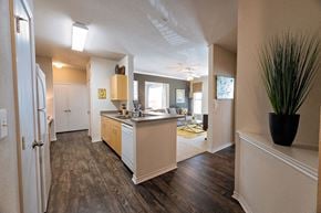 Austin apartment for rent - A kitchen with a refrigerator, sink, and cabinets.