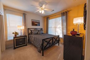 Austin apartment for rent - A bedroom with a bed, nightstand, and dresser.