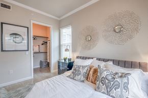 Aubrey apartment for rent - A bedroom with a large bed and a painting on the wall.
