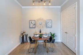 Aubrey apartment for rent - A dining room with a table set for two and a potted plant.