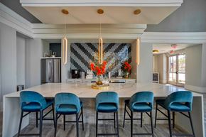 Houston apartment for rent - a large kitchen with a marble counter top and blue chairs